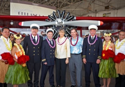 Hawaii Governor Linda Lingle and Hawaiian Airlines President and CEO Mark Dunkerley (center) stand in front of the company's first airplane, the 1929 Bellanca CH-300 Pacemaker, following today's ceremony to welcome home this rare artifact of Hawaii aviation history. Flanking them are Hawaiian Airlines pilots Paul Weston, Curtiss Aldrich, and Bruce Clements (left to right) dressed in 1929-era pilot uniforms, and members of the Hawaiian Airlines Serenaders hula troupe.  (PRNewsFoto/Hawaiian Airlines)