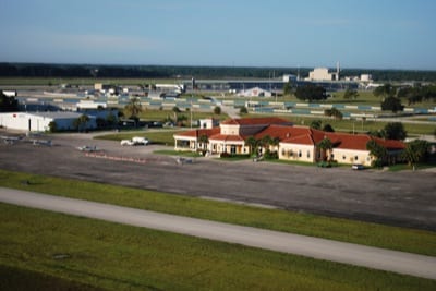 A view of the Sebring ramp on takeoff from runway 18; racetrack and grandstands are in the background.