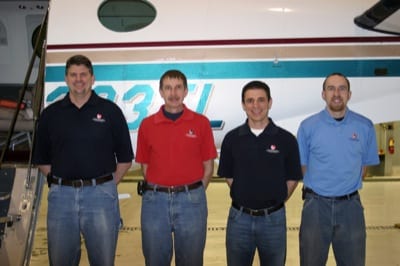 Todd Scholten, Roger Powers, Mark Linsley and James Powers prepare for the Haiti flight.