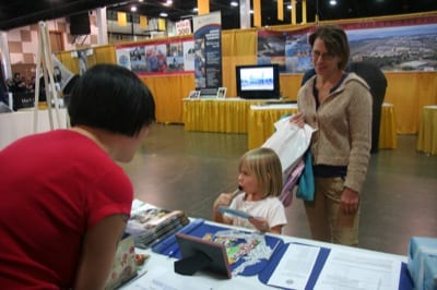THE NEXT GENERATION: Kam Yee, a Seattle-area member of the Ninety-nines, talks to a future pilot. The Ninety-nines were one of several not-for-profit groups with informational displays. Several Ninety-nines report that the recent Amelia Earhart movie has sparked a renewed interest in the group. Earhart was the first president. For more information: Ninety-nines.org