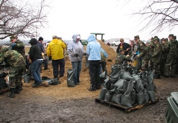 Flood Civil Air Patrol members pitch in filling and positioning sandbags to counter Red River flooding in the Fargo, N.D., area in March 2009.