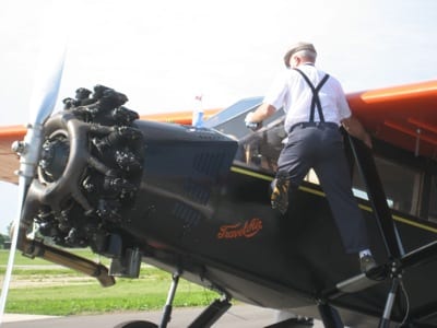 hank Galpin cleaning the Travel Air 6000 before his media flight with local TV reporter