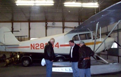 Discussing upcoming repair on J-4 floats, a result of operating off of a lake with skim ice