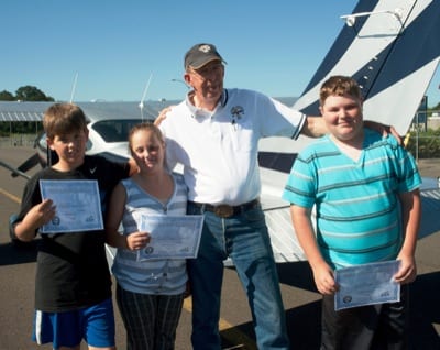 Larry Durst flew his 5,000th Young Eagle on June 7: Cole Brecht, 12 (far right) of Looking Glass, Ore. Also (l-r): Young Eagles Jesse Brecht, 10, and Lily Creekmore, 11.