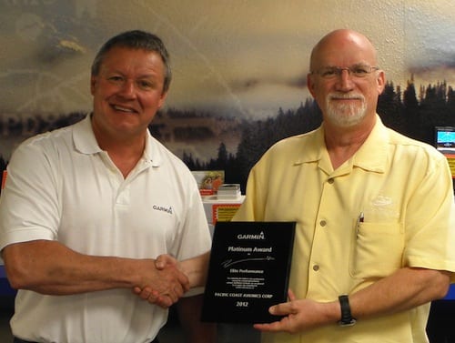 Garmin's Wayne McGhee (left) congratulates Dewey Conroy for his Platinum Elite Dealer Award.