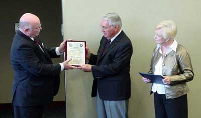 PS2 Paul Siedenburg (center) is presented his award by Larry Arenholz from the Des Moines FSDO while Paul's wife, Minnette, looks on.